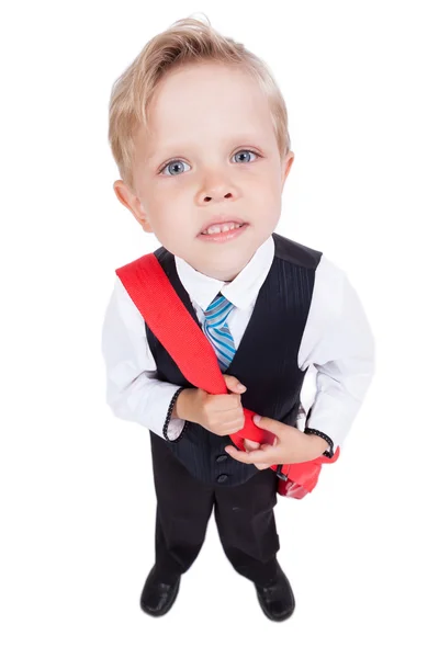 Little schoolboy on a white background with a backpack in a busi — Stockfoto