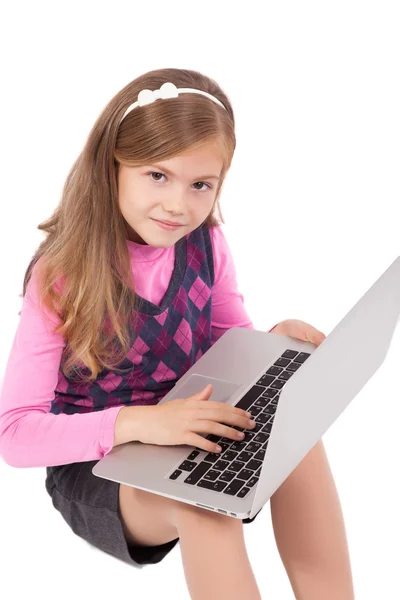 Schoolgirl on a white background with a laptop — Stock Photo, Image