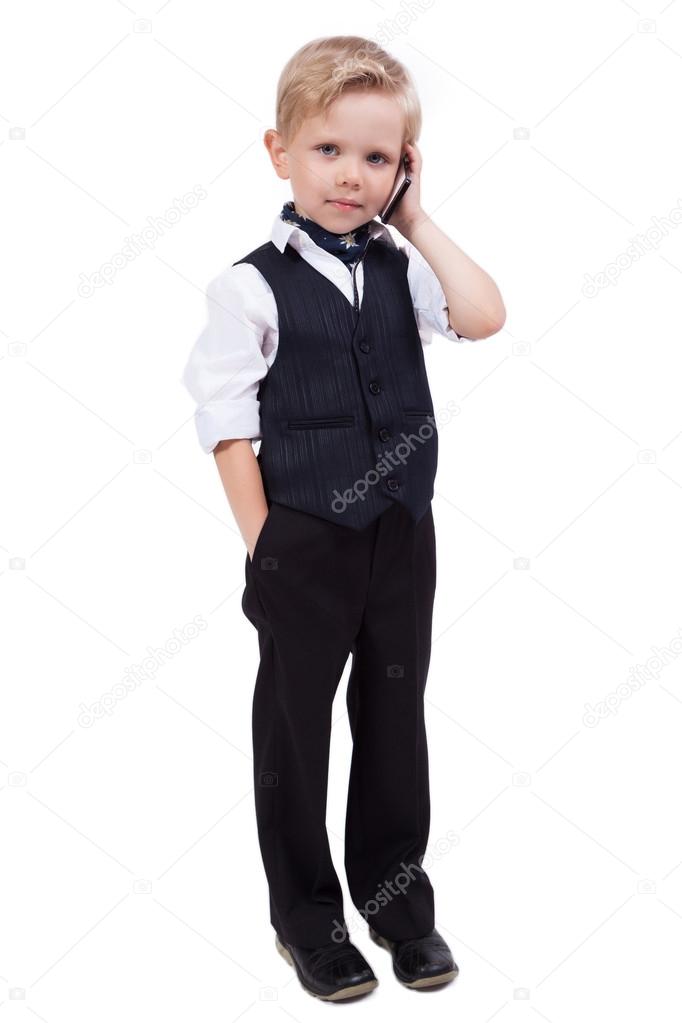 little schoolboy on a white background talking on the phone