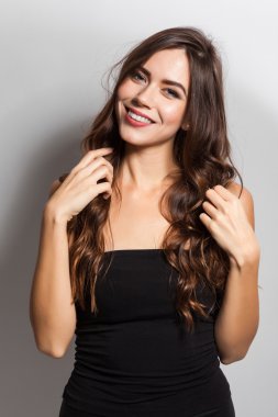 Student smiling brunette with white teeth on a white background