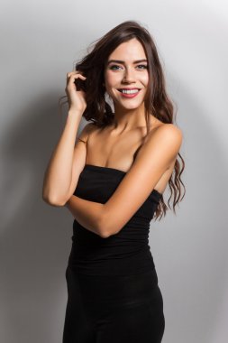 smiling young student with white teeth and dark hair on a white