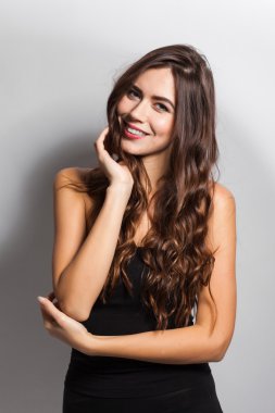 Business portrait of a smiling brunette in a business suit on a