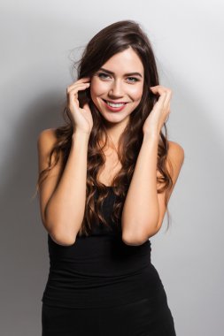 Business portrait of a smiling brunette in a business suit on a