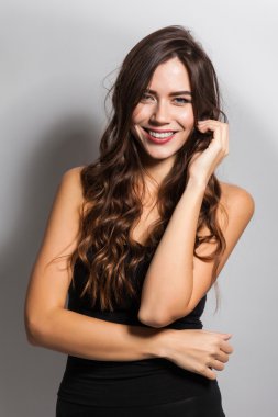 Business portrait of a smiling brunette in a business suit on a