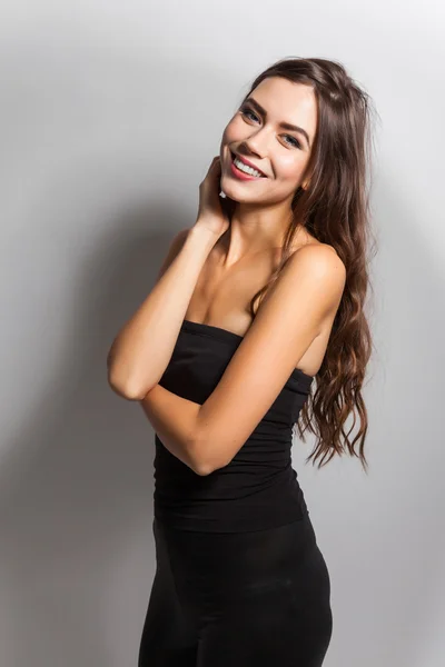 Student smiling brunette with white teeth on a white background — 스톡 사진