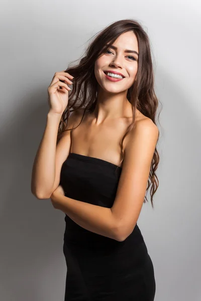 Smiling young student with white teeth and dark hair on a white — Stock fotografie