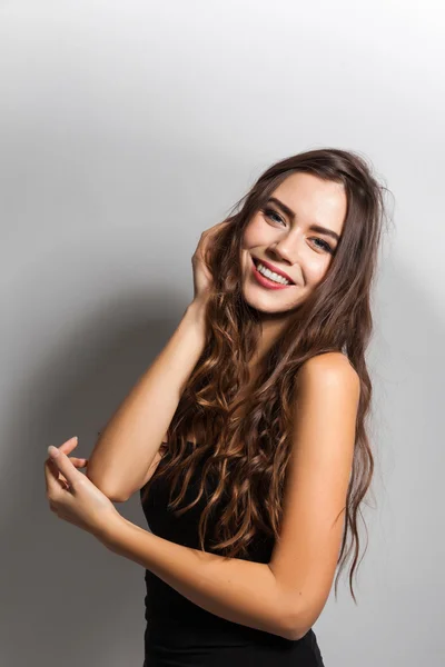 Smiling young student with white teeth and dark hair on a white — Stockfoto