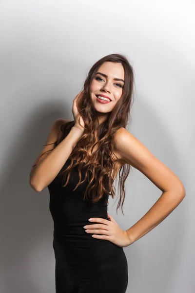 Smiling young student with white teeth and dark hair on a white — Stock fotografie