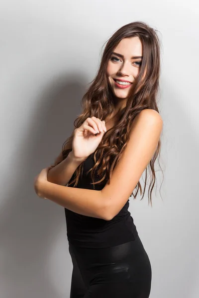 Smiling young student with white teeth and dark hair on a white — Stockfoto