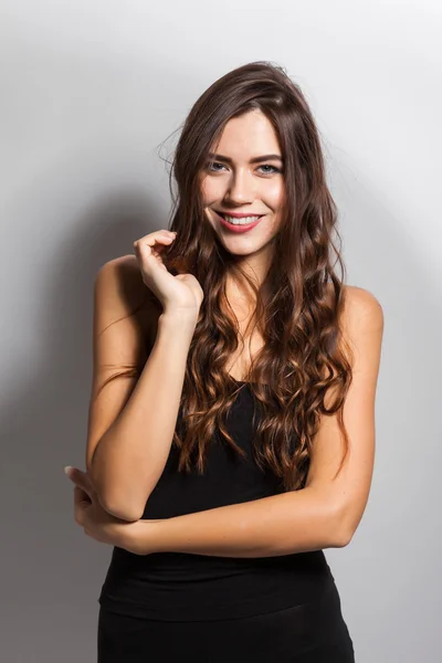 Business portrait of a smiling brunette in a business suit on a — Stok fotoğraf