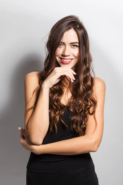 Business portrait of a smiling brunette in a business suit on a — Stock Fotó