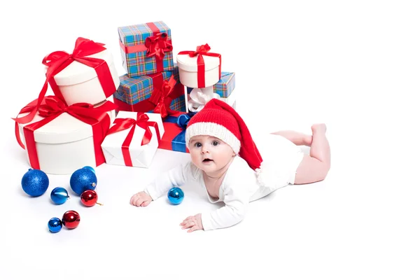Lindo bebé con una gorra roja de Año Nuevo con una sonrisa en su cara acostada — Foto de Stock