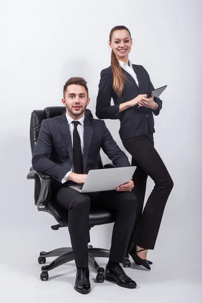 Young creative expert sitting in a black leather office chair wi — 스톡 사진