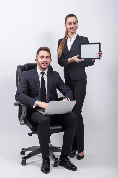 Young creative expert sitting in a black leather office chair wi — Stok fotoğraf