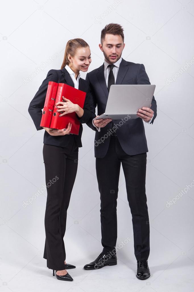 two modern businessman standing on a white background with a lap
