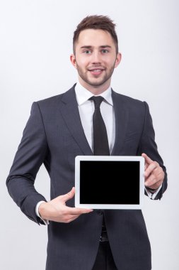 Smiling successful young student on a white background in a clas