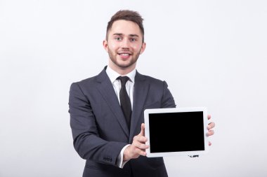 successful young businessman with a smile on his face shows the 