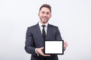 successful young businessman with a smile on his face shows the 