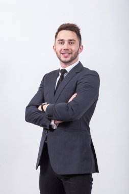 Young businessman sitting on a white background in a classic sui
