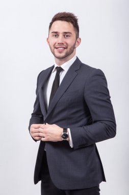 Young businessman sitting on a white background in a classic sui
