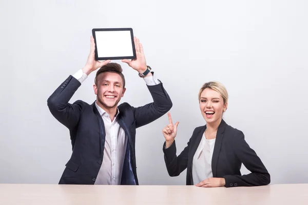 Man and woman business people sitting at the table, a man holds — Stok fotoğraf