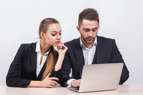 Man and woman sitting in a business suit at a table in front of — 스톡 사진