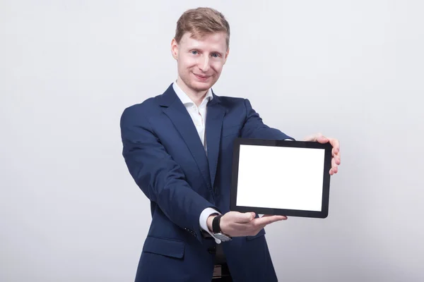 Young student in a blue jacket on a white background holding a t — 图库照片