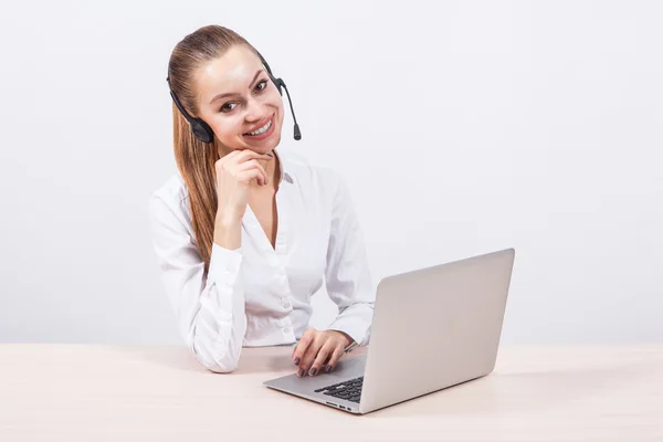 Girl in a white blouse with a headset on his head sitting in fro — Stock Photo, Image