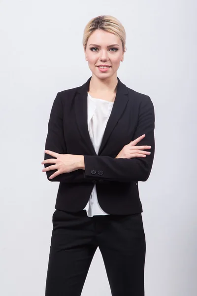 Business lady blonde in black stylish suit standing on a white b — Stock Photo, Image