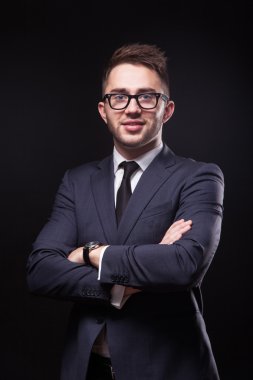 stylish, trendy businessman in a business suit and wearing glass