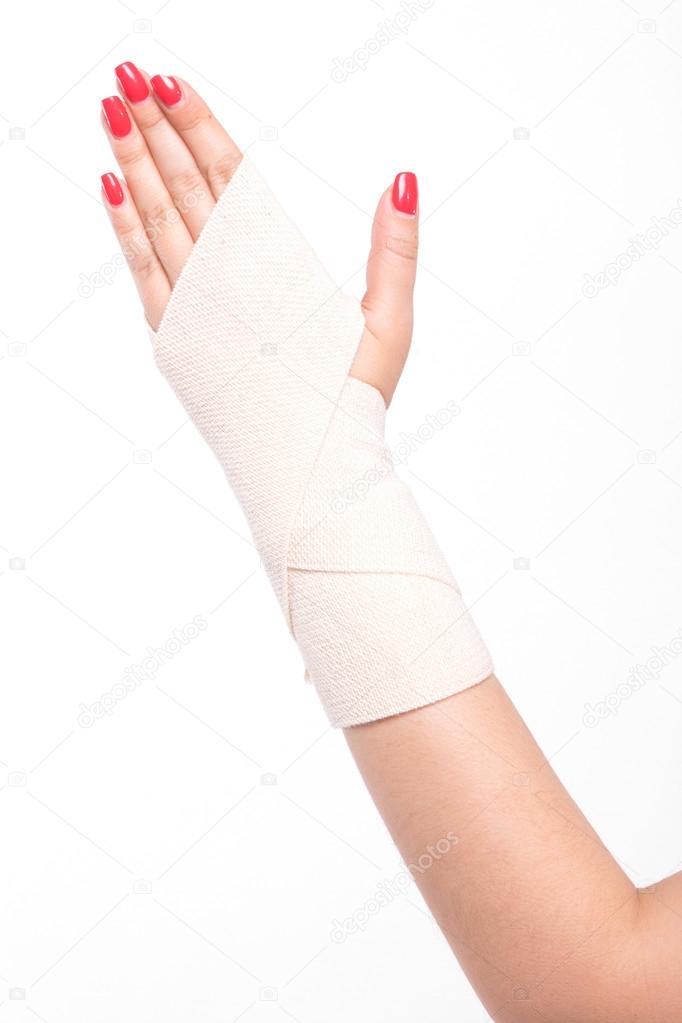 studio shot female wrists tied with an elastic bandage