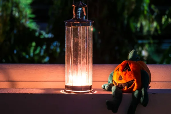 Halloween pumpkin and lamp, candle light in the darkness.