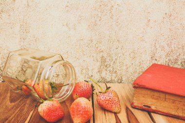 Çilek kavanoz, ahşap, proses renk üzerinde kitapla Vintage Ton