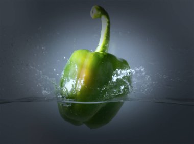 Bir tutam suyla suya atılmış eski yeşil çan biberleri..