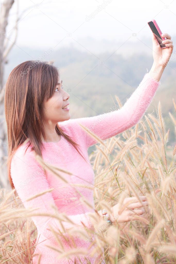 Beauty Girl on a meadow Outdoors enjoying nature. Cheerful woman on sunset. Lifestyle and happiness concept
