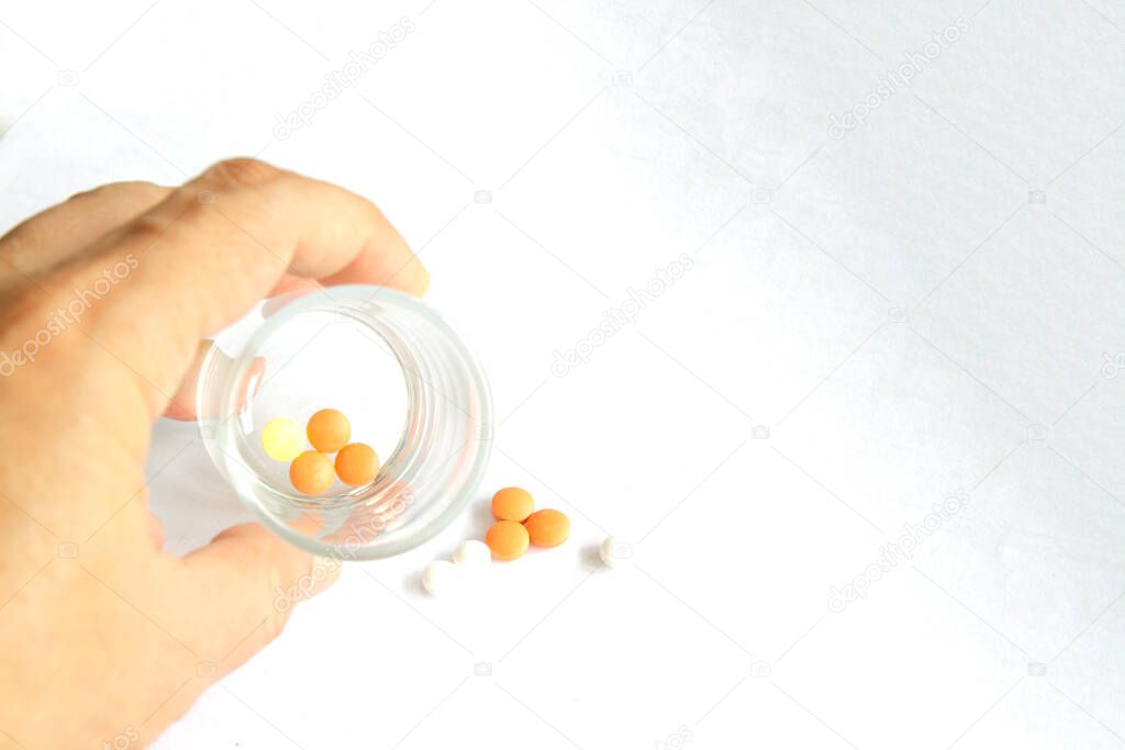 a hands holding Medicine pills or capsules in box,Pharmaceutical medicament, cure in container for health.