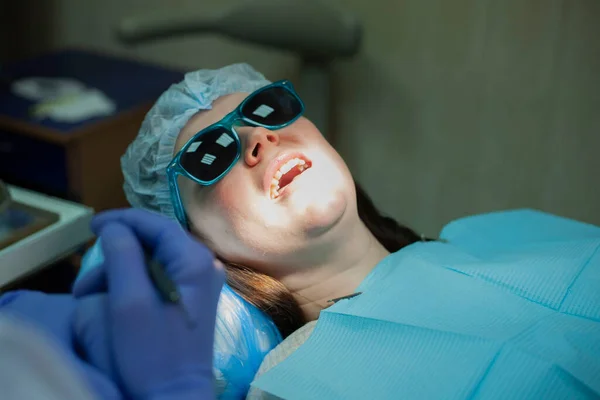 Young woman at the dentist appointment. Doctor's appointment. Dental treatment.