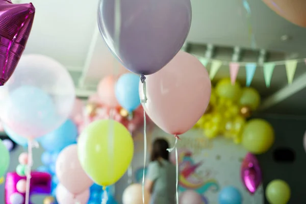 first birthday. decoration with balls. wedding decoration. children\'s party. birthday party. young woman decorates an evening party. Decoration for a children\'s party. Birthday decoration.