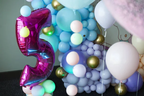 first birthday. decoration with balls. wedding decoration. children\'s party. birthday party. young woman decorates an evening party. Decoration for a children\'s party. Birthday decoration.