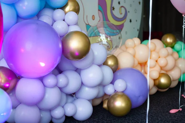 first birthday. decoration with balls. wedding decoration. children\'s party. birthday party. young woman decorates an evening party. Decoration for a children\'s party. Birthday decoration.