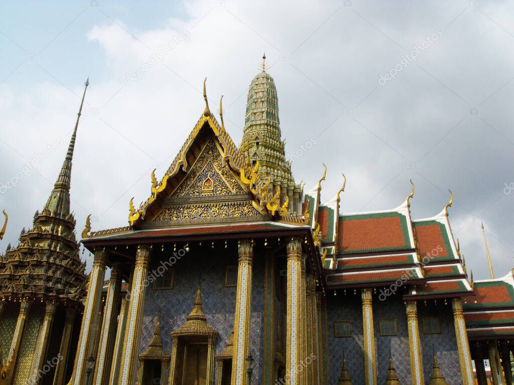 Bangkok, Thailand, January 25, 2013: Stupas next to a building at the Royal Palace in Bangkok