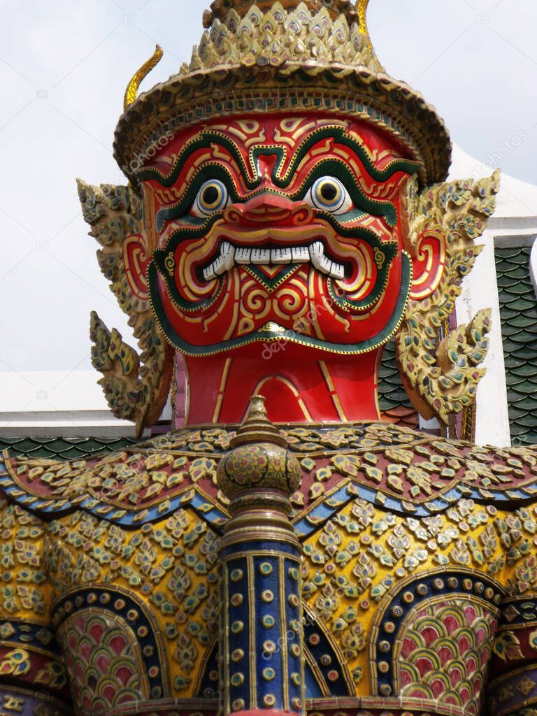 Bangkok, Thailand, January 25, 2013: Sculpture of a warrior with a red face at the Royal Palace in Bangkok