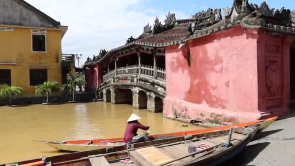 Une femme dans un bateau à côté du célèbre pont japonais de Hoi An après le passage du typhon Molave — Video