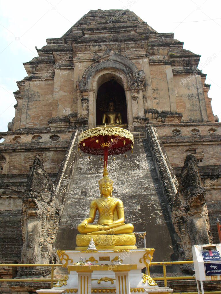 Chiang Mai, Thailand, April 25, 2016: Golden Buddha at the base of the Wat Chedi Luang stupa in Chiang Mai