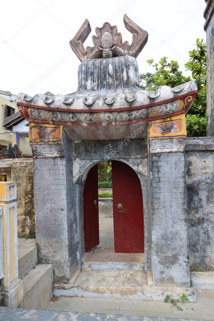 Hoi An, Vietnam, May 6, 2021: Vertical view of the left side door of the Ba Mu Temple gate in Hoi An