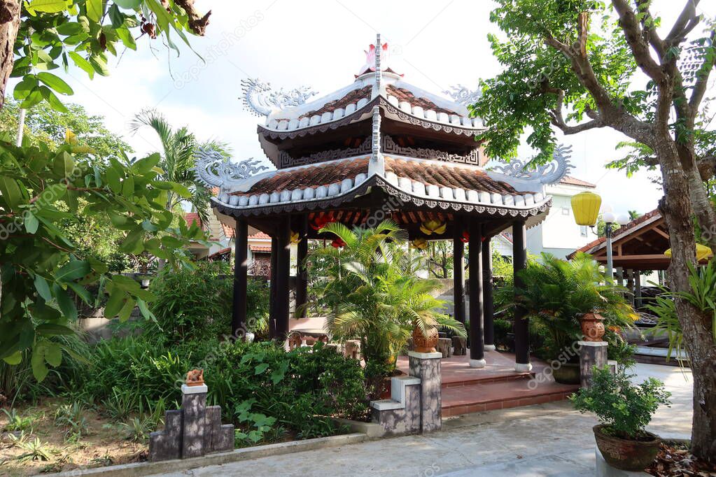 Hoi An, Vietnam, September 22, 2021: Pagoda in the gardens of Nam Ton Temple