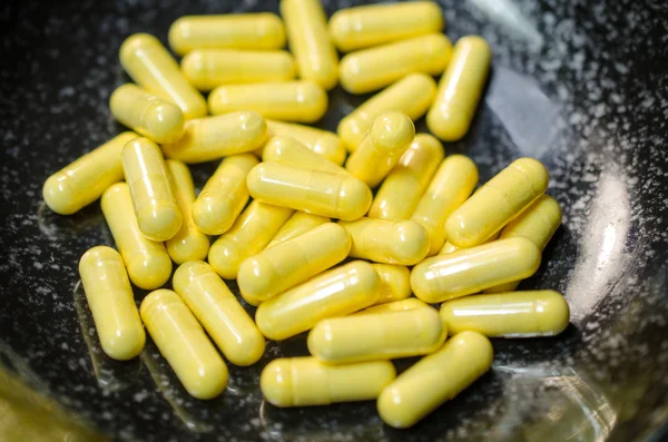 Group of yellow capsules — Stock Photo, Image