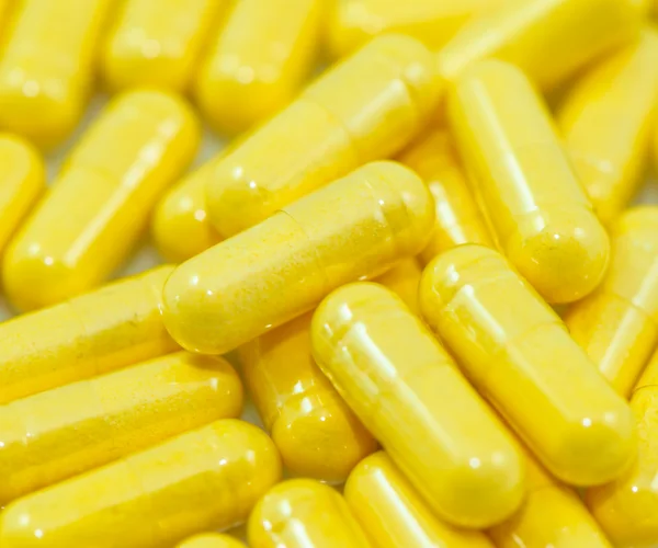 Yellow Drug Capsules closeup — Stock Photo, Image