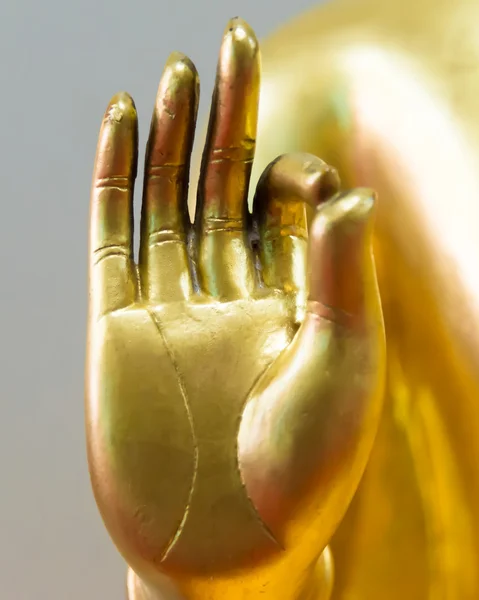 Buddha Hand in Hand im Friedenszeichen lizenzfreie Stockbilder