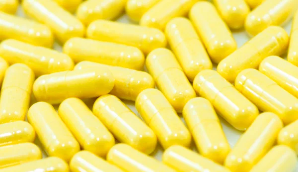 Yellow drug capsules macro — Stock Photo, Image